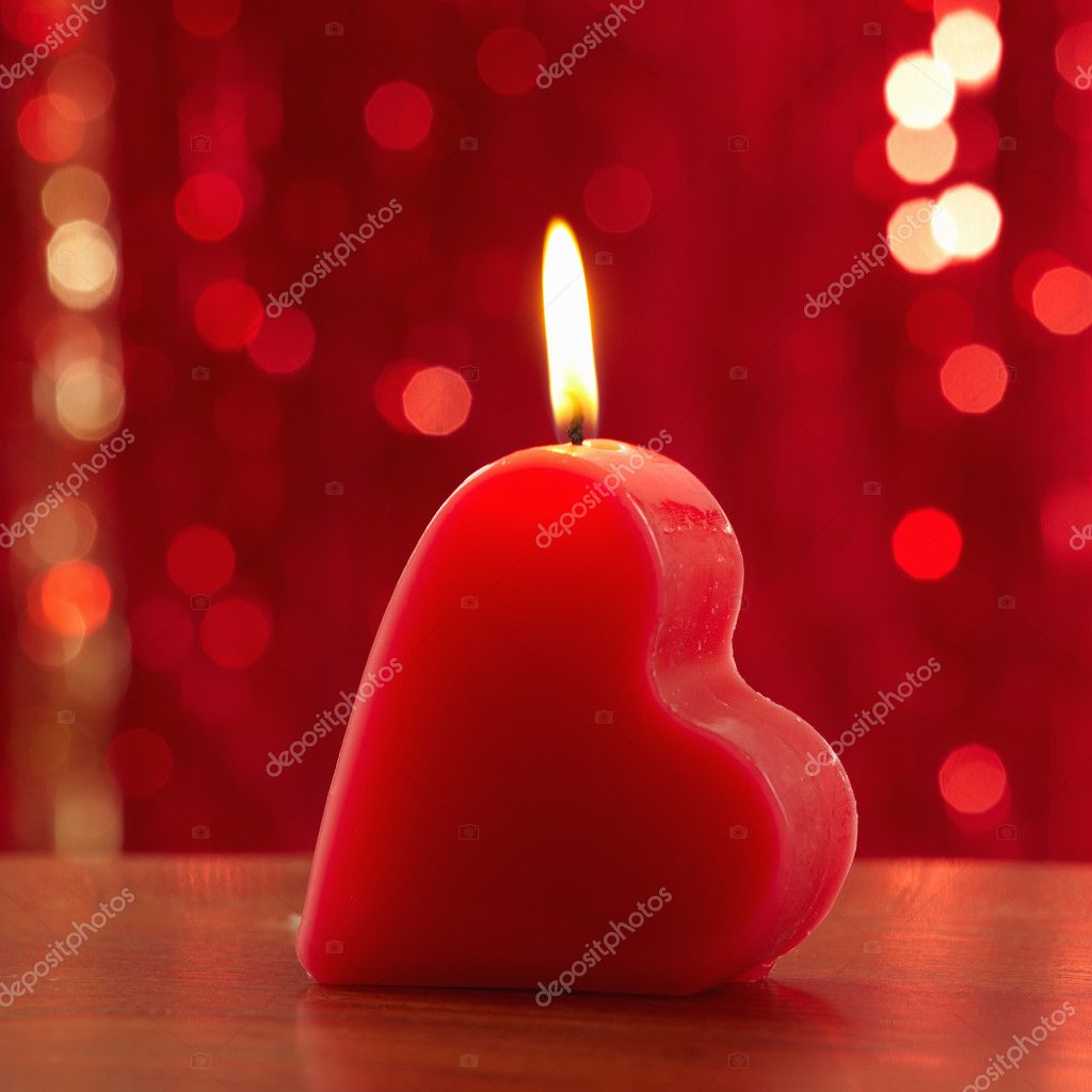 Red burning heart shaped candle Stock Photo by ©zmaris 4654859